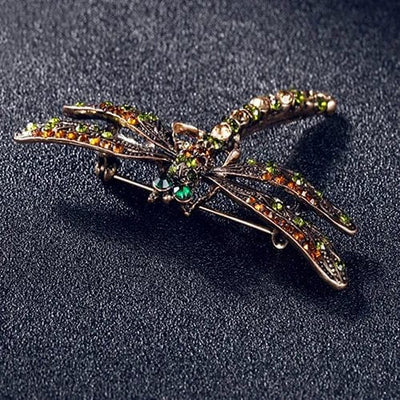 vintage dragonfly brooch front view on a blak background