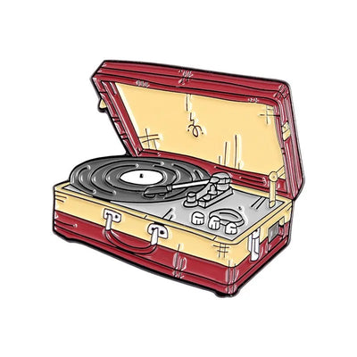 enamel pin of a vintage record player in a suitcase on a white background