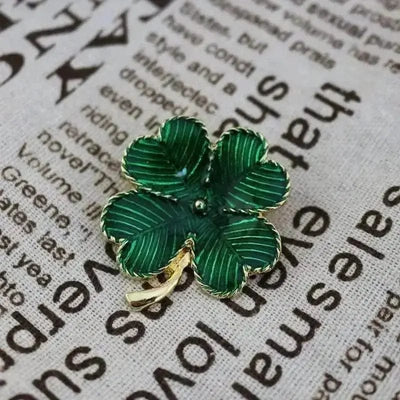 BROOCHITON Brooches Green Four-leaf Clover Brooch on a newspaper