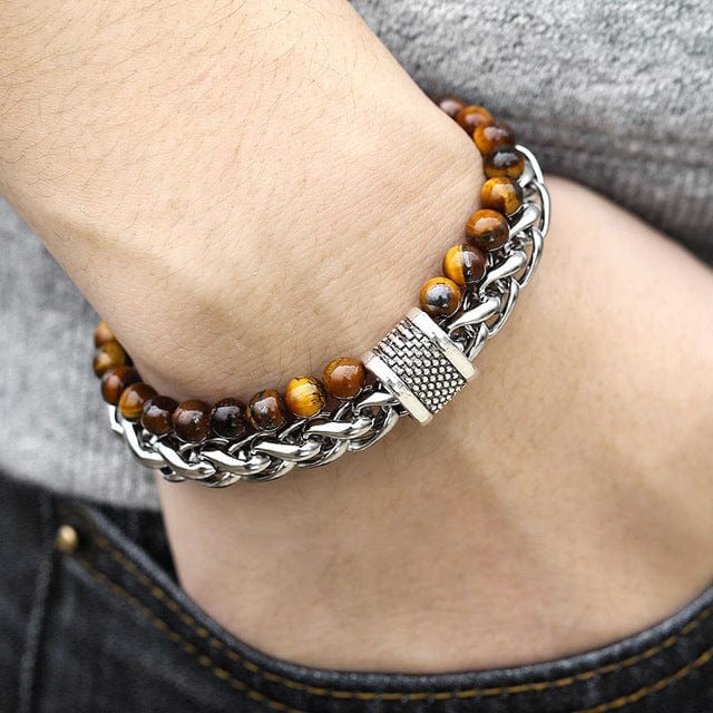 a man hand in jeans pocket wearing a double band bracelet brown beads