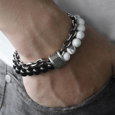 a man hand in jeans pocket wearing a double band bracelet black and white beads