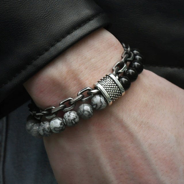 a man hand in jeans pocket wearing a double band bracelet black and grey beads