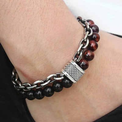 a man hand in jeans pocket wearing a double band bracelet black and brown beads