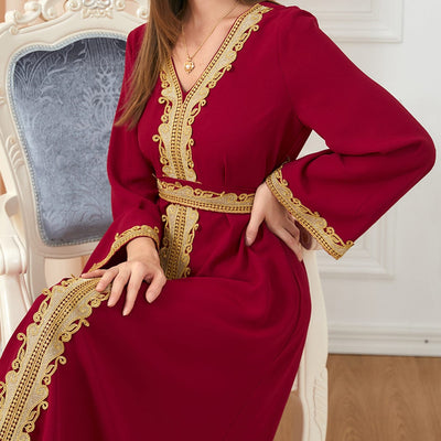 a woman wearing red solid color embroidery long-sleeved dress close up view