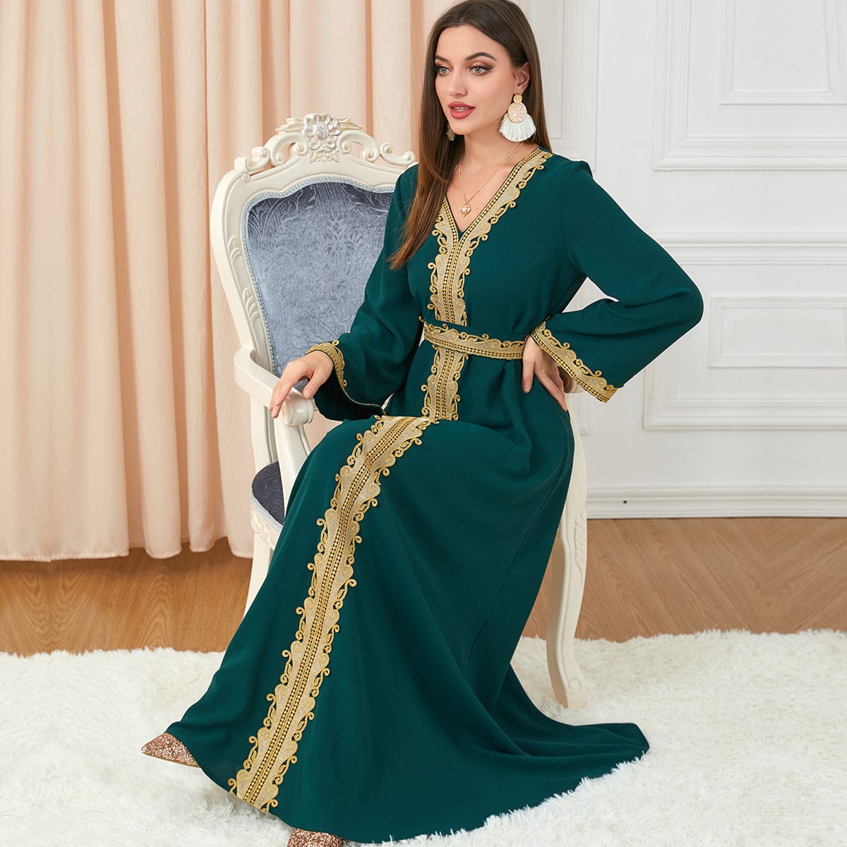 a woman wearing a Green solid color embroidery long-sleeved dress and sitting on armed chair