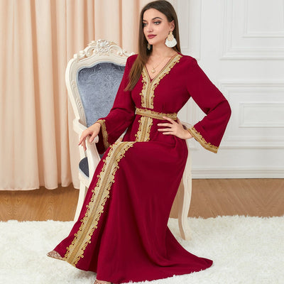 a woman wearing Red solid color embroidery long-sleeved dress and sittin on armed chair